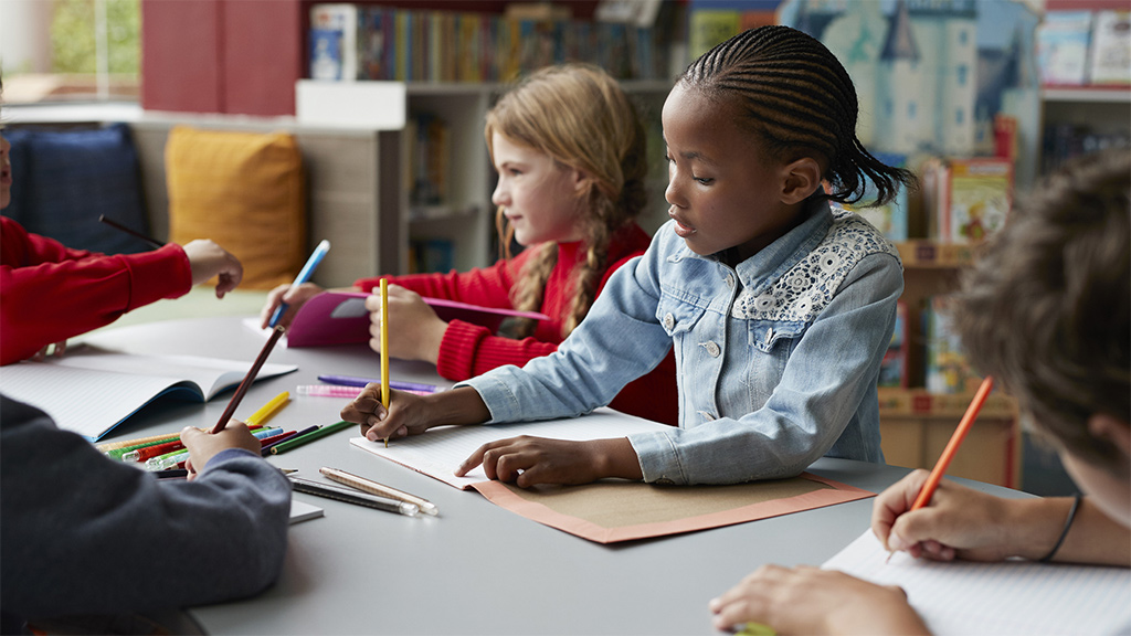 Kids writing their ideas on paper