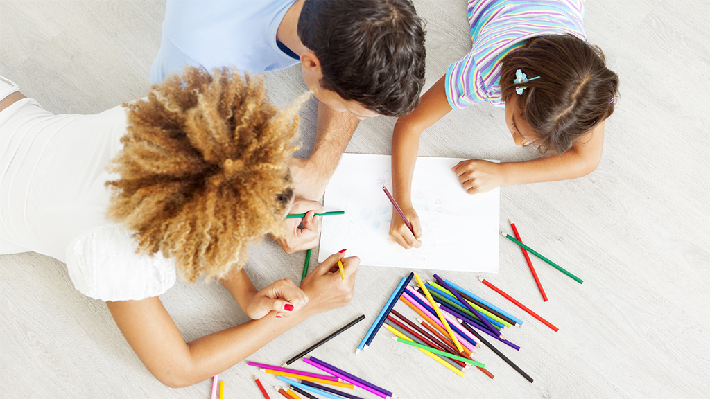 Small group of kids writing their thoughts on paper