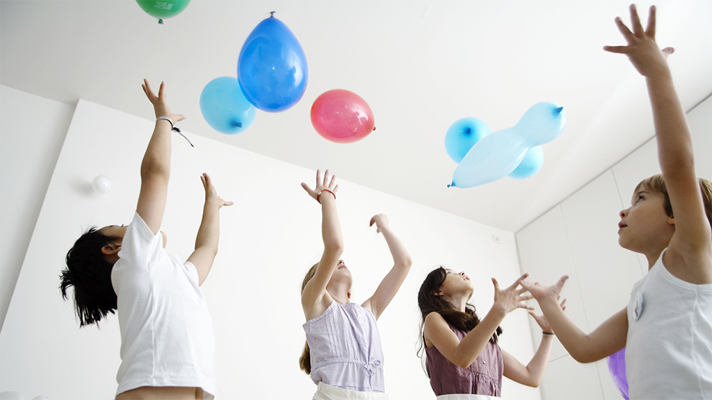 Small group of kids playing fitClub balloon toss game