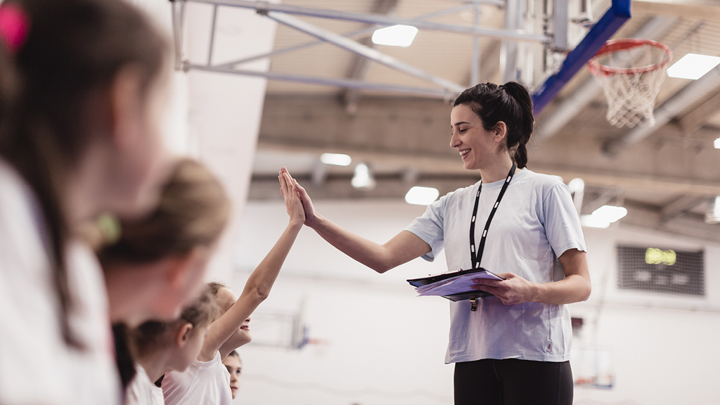 kids getting ready to play a game in a gym