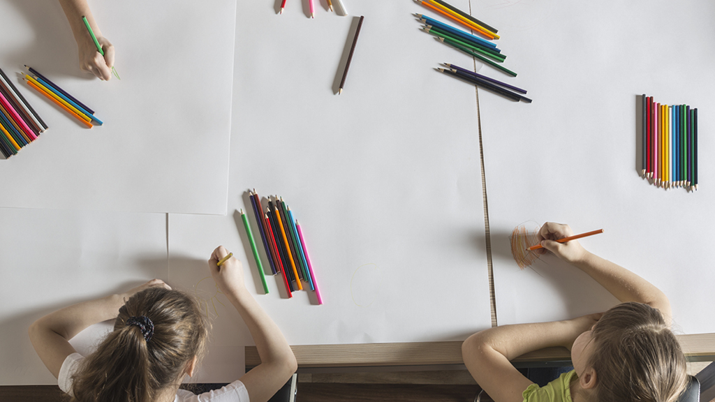 Group of kids writing ideas on paper