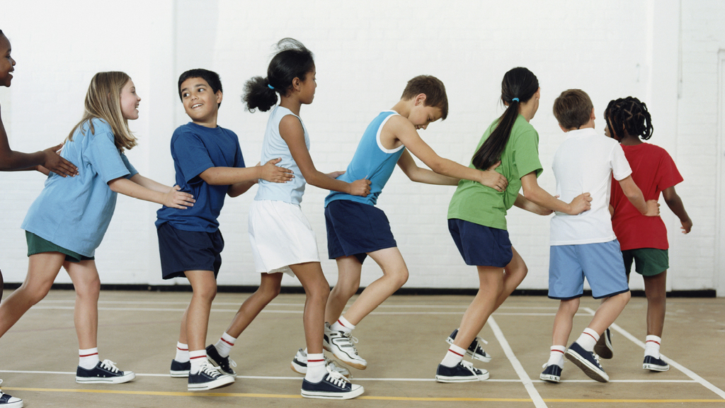Group of kids making a human chain in a gym