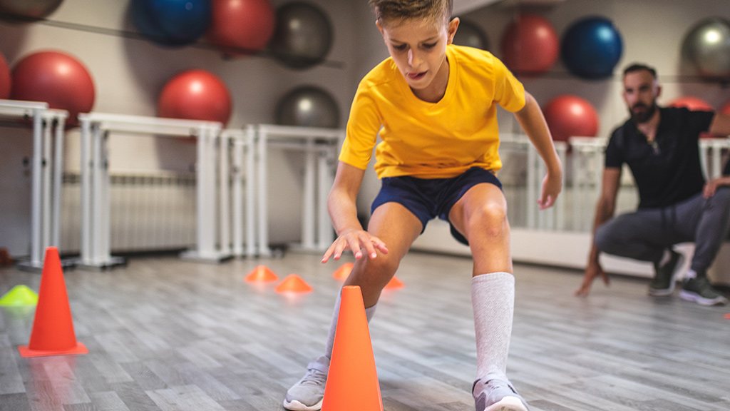 Boy playing game and standing a cone up
