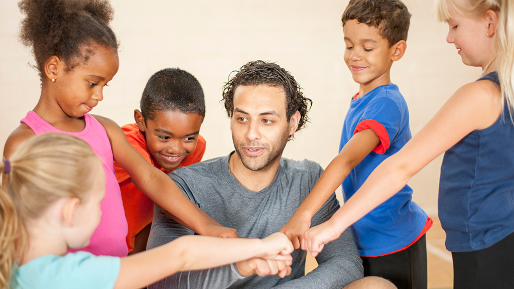 Teacher and students getting ready to play a game.