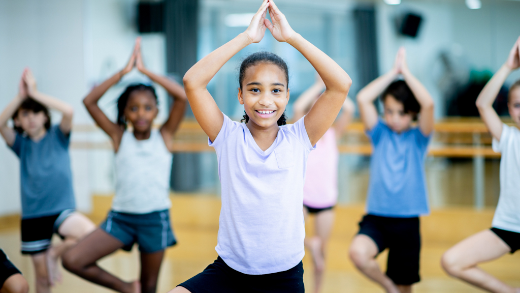 Children practicing tree pose yoga - Sanford fit