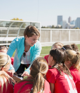 Coach and team huddle - Sanford fit
