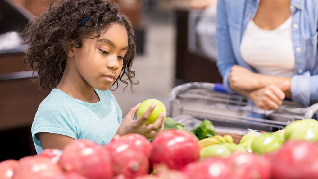 Child examining fruit - Sanford fit